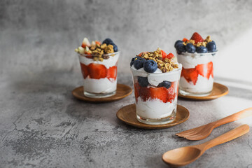 Japanese popular dessert parfait made with fresh fruit, yogurt and granola isolated on cement background - Powered by Adobe