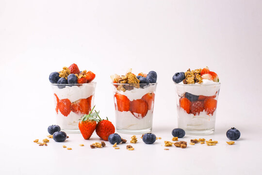 Row of Japanese popular dessrt made with fresh fruit, yogurt and granola  parfait on white background