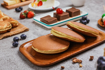 Japanese snack Dorayaki, dorayaki is Japanese bread, Japanese pancake with red bean paste inside served on wooden table