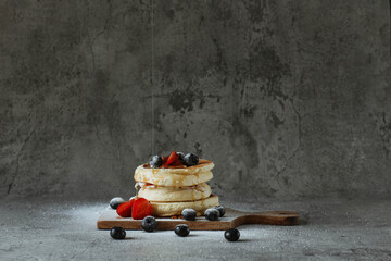 Japanese specialties called souffle pancakes served on a cement background