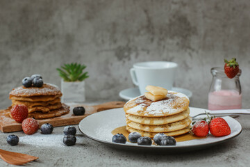Various popular pancakes isolated on cement background