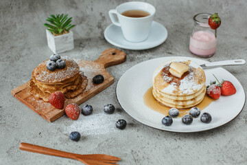 Various popular pancakes isolated on cement background