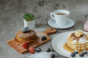 Various popular pancakes isolated on cement background