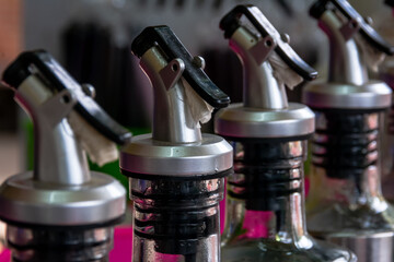 line of professional stainless steel bottles cap of syrup from the street food bar vendor