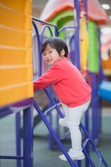 Fototapeta premium Child playing on outdoor playground.