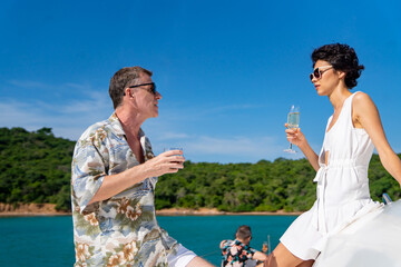 Caucasian couple enjoy outdoor luxury party drinking champagne with talking together while...