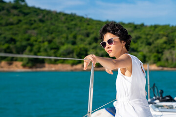 Portrait of Caucasian woman enjoy luxury lifestyle catamaran boat sailing and looking at beautiful...
