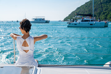 Portrait of Caucasian woman enjoy luxury lifestyle catamaran boat sailing and looking at beautiful...