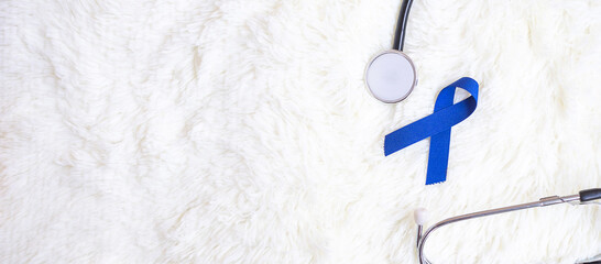 March Colorectal Cancer Awareness month, dark Blue Ribbon with stethoscope on white background for...