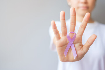 Fototapeta World cancer day (February 4). Woman hand holding Lavender purple ribbon for supporting people living and illness. Healthcare and medical concept obraz