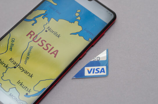 Smartphone and Visa Bank Card Piece against a gray background.