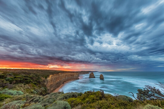 Australia, Victoria, Long exposure of Twelve Apostles and Gibson Steps in Port Campbell National Park at cloudy dawn