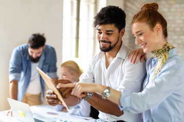 Portrait of creative business people team working together and smiling in office.