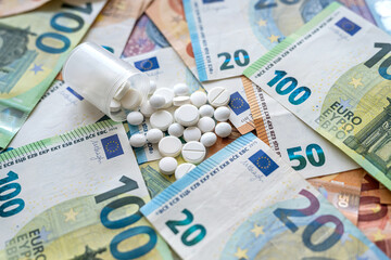 Medical tablets on euro banknote as background