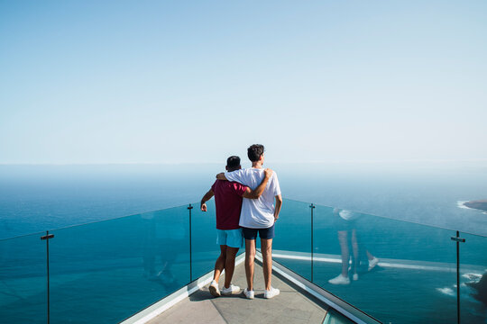 Young friends with arms around looking at sea from Mirador Del Balcon, Grand Canary, Canary Islands, Spain