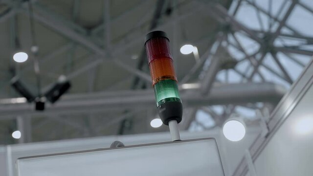 Industrial signal pole, emergency luminaire, LED, tricolor, warning signal - red, yellow, green - in industrial production, warns of the status of equipment. Shot in motion. Closeup