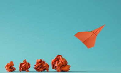 New ideas or transformation concept with crumpled paper balls and a paper plane, teamwork, creativity, business concept