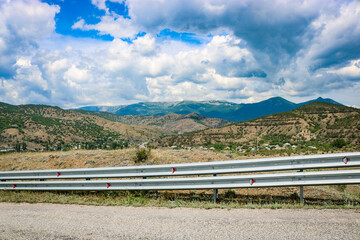 View from the highway to the mountain plateau Karabi-Yayla. Crimean landscape with mountains, vineyards and blue sky with cirrus clouds.