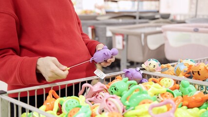 Pregnant woman watching toys for newborn