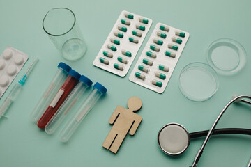 Stethoscope, syringes, blood sample and pills on blue background, healthcare and early diagnostic concept