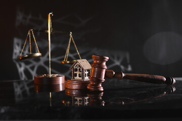 Concept of suing for property. Wooden gavel with house close-up - obrazy, fototapety, plakaty