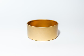 Yellow golden round empty metal box on white background.Soft focus,copy space.