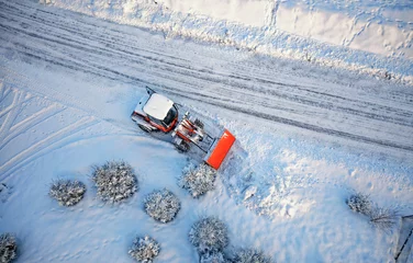 Foto op Aluminium Snow removing with red tractor on the road. Suny winter day, Drone top view. © Photobes
