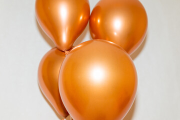 golden balloons on a white studio background.Indoors shot.