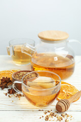 Concept of hot drink with buckwheat tea on white wooden table