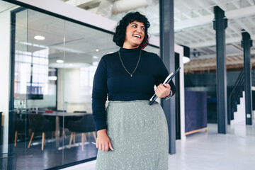 Mid-adult businesswoman smiling cheerfully in a creative office