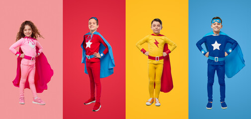 Fearless kids in superhero costumes in studio - obrazy, fototapety, plakaty