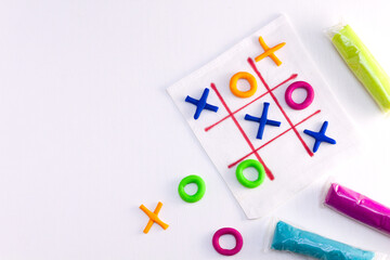 Tic tac toe game from colorful plasticine. DIY concept, simple handmade game.