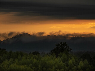 Amazing Sunrise Over Misty Landscape. Scenic View Of Foggy Morning Sky With Rising Sun Above Misty Forest
