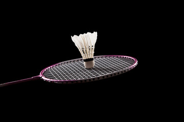 Badminton shuttlecock and badminton racket on black background