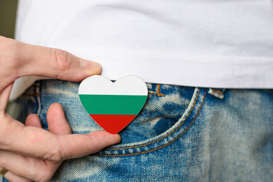 Patriot of the Bulgaria! Wooden badge with Bulgaria flag in the shape of a heart in a man's hand.