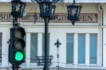Decorated vintage and old traffic green light with retro concept metal work design on the heritage city street at Bandung