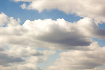 Fototapeta premium Cumulus clouds, gentle air clouds in the blue sky on the sunrise