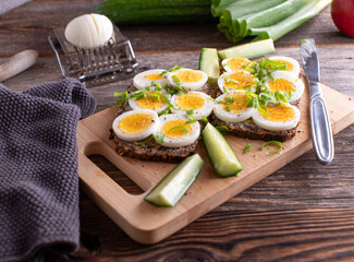 Sandwich with boiled eggs and herbs on whole grain bread