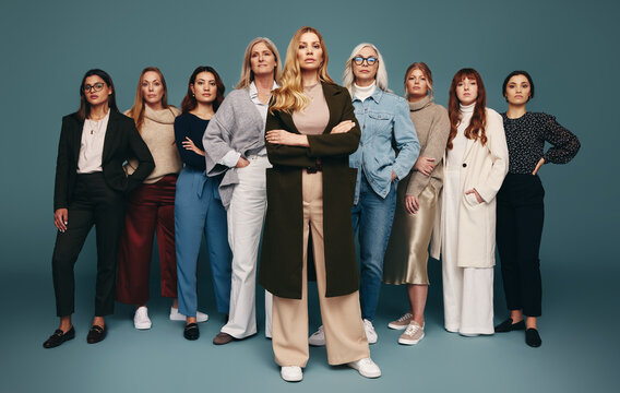 Self-assured woman standing with a group of empowered women