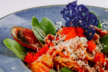 Pasta with assorted seafood in tomato sauce