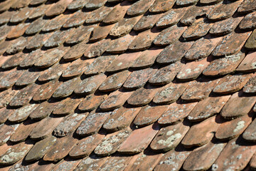 Shallow depth of field (selective focus) details of Transylvanian saxon traditional clay tiles.