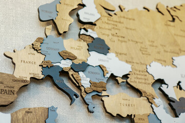 Wooden world map on thr wall. Geography concept. Background for travel. Logistics and transportation, worldwide business. Europe close up