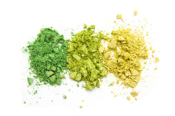 Green and yellow colorful eye shadow, crushed cosmetic isolated on white background. A smashed, bright toned eyeshadow make up palette