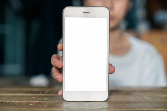 Woman hand holding smartphone and the screen is blank, social network concept, copy space for your advertising..