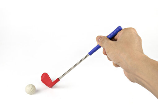 Hand holding golf club and golf ball on white background.