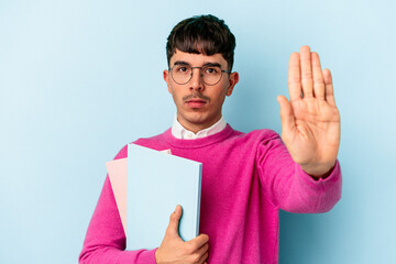 Young mixed race student man isolated on blue background standing with outstretched hand showing...