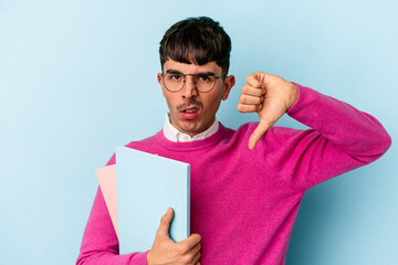 Young mixed race student man isolated on blue background showing a dislike gesture, thumbs down. Disagreement concept.