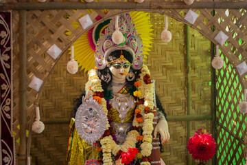 idol of hindu goddess saraswati being worshipped during saraswati puja festival in bengal.