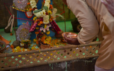 saraswati puja festival rituals being performed by priest. idol of hindu goddess saraswati in...