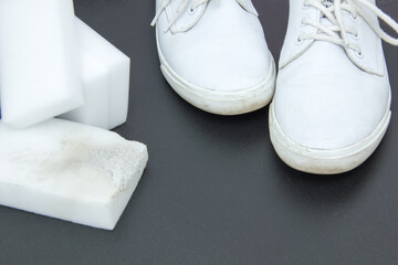 Melamine sponge and white sneakers on a bright background. Purity concept
